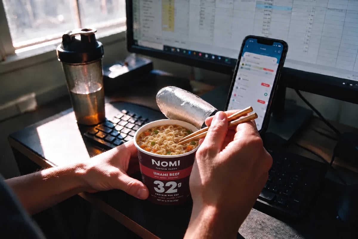 An open NOMI cup at a desk at lunch